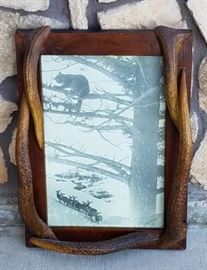 Stephen N. Leek photograph of elk and a mountain lion in a frame with elk antler points from the historic Leeks Lodge in Jackson, Wyoming.