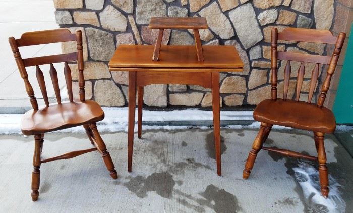 Made by Cushman Colonial Creations of Bennington, Vermont. Solid birch wood with cherry stain. Circa 1950s/60s. Excellent condition. Top of table pivots and unfolds, with storage underneath. Would make a good dinette set for a small space. Table is 30" x 15" when folded, and 30" x 30" when unfolded. Also includes a small footstool in worn condition.
