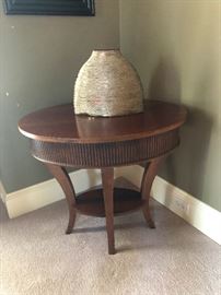 Circlular side table with artsy urn type thing. You want this!