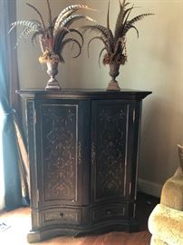 This is probably the nicest entertainment cabinet you'll ever see. And look, it's topped with pheasant feathers!