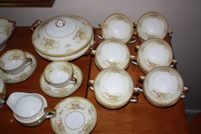 These are Noritake.  The pattern name is Manarose.  We looked up the name of the pattern-it is not written on the back of the individual pieces.  There are several nice serving pieces included, plus it appears there is a set of twelve.  