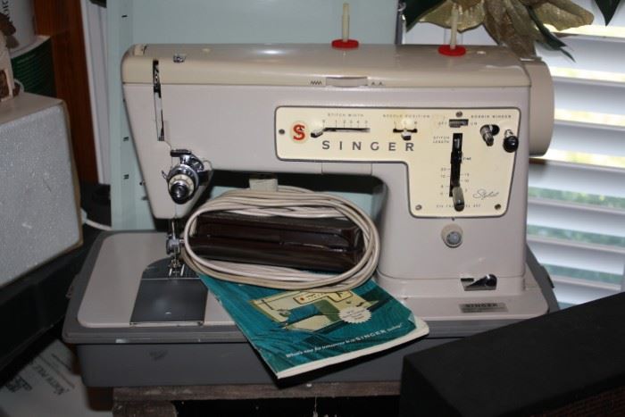 Singer Sewing machine with manual.  We think it comes from the 1950's and we were told it worked before it was put away.  