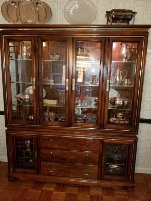 Lighted, glass front china cabinet with drawers
