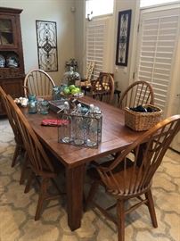 A dining table with great chairs. Beautiful wood, the farm house look for today’s home.