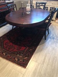 a gorgeous oval table with one leaf insert. Super nice. Extremely well made and sturdy dining table with impressive center base. Beautiful solid wood table with attractive matching chairs that have a light faux finish hand painted on the edges
