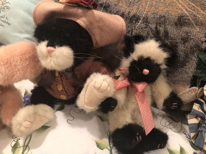 a collection of stuffed kittens waiting to go