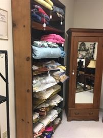 Collection of linen, small antique English looking oak wardrobe filled with shelves.   