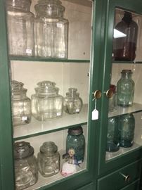 Antique medicine cabinet made in Louisville, display of apothecary bottles and old ball jars
