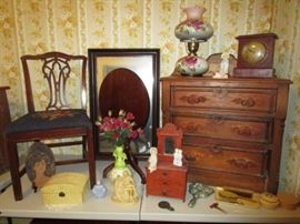 Antique chair w/ needlework seat, mirror, tilt top table, 3 drawer chest, hand painted lamp, antique clock, celluloid dresser set, metal hand mirrors,  wooden carving dated 1970, misc. collectibles