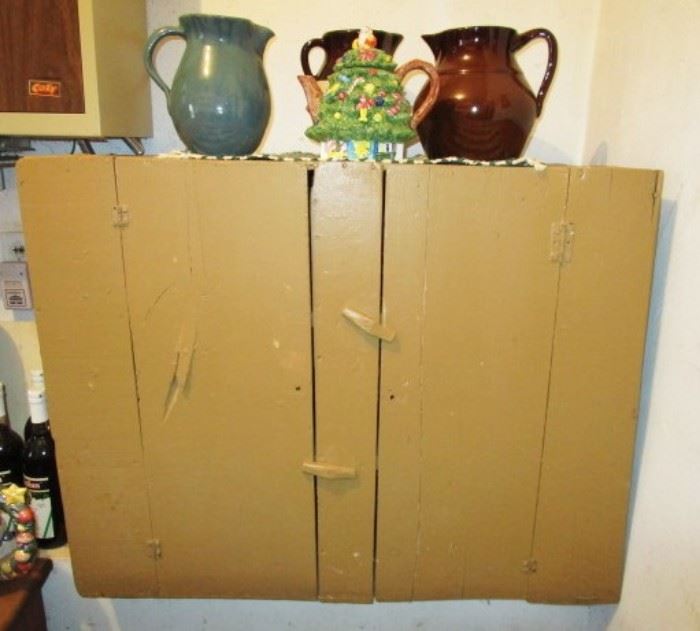 Primitive painted cupboard, stoneware pitchers
