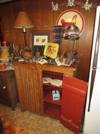 Primitive cupboard w/ vintage kitchen items, cookie molds, plunger butter/cookie mold, lamps, wall decor including porcelain chicken sign, lamps, etc.