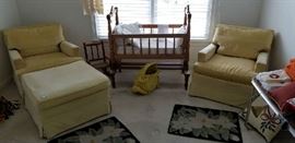 2 gold velvet chairs and one ottoman. The arts and crafts circa 1890-1910 cradle is at the center