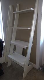 One section of a 3 section leaning shelf unit. Completely assembled it would be approximately 84" long and 78" tall with a total of 12 shelves