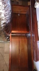 There are 2 of these clothes hanging display units. They are stacked on their sides due to limited space. Turned upright, they are 7'7"h x 29-3/4"w x 18-3/4"d with a bar on the bottom and extended hook on top