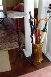 Antique ceramic vase, canes, marble top candle stand.