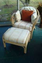One of two rattan chairs, each with ottoman.