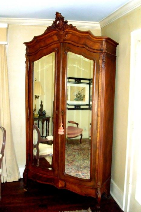 Early 1800's French armoire with mirrored doors and shelves and drawer inside.