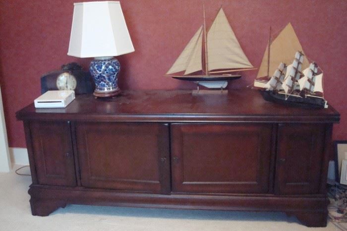 Music/television cabinet with ship models and lamp.