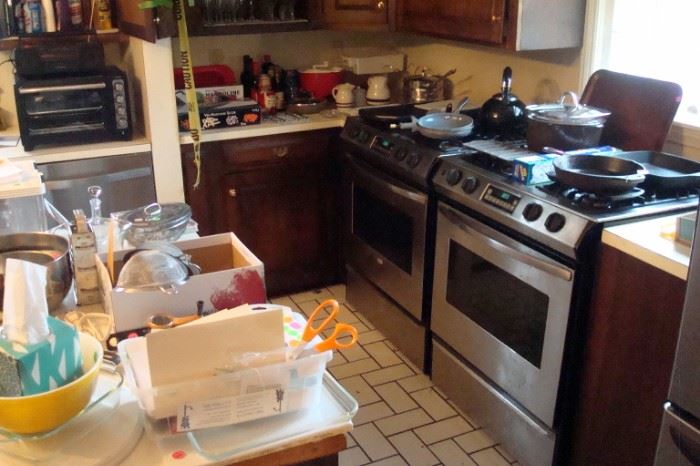 Two gas ranges to be sold and removed by buyer plus kitchen stuff. At the left top an new Kitchen Aid toaster oven.
