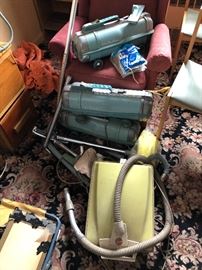 Vintage Hoover and Electrolux vacuum cleaners with attachments