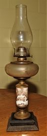 ANTIQUE OIL LAMP WITH CAST IRON BASE AND PAINTED DECORATIONS