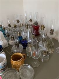 Large collection of vintage and antique oil lamps.