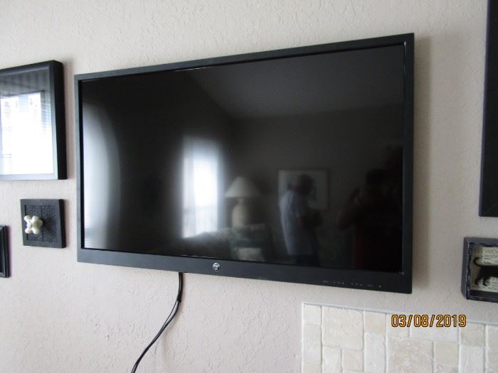 42" TV ON THE WALL.. HAS A MOUNTING BRACKET THAT MUST STAY.. 