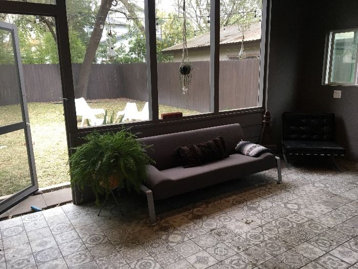 Grey couch, very comfortable. Hanging, glass plant holders.