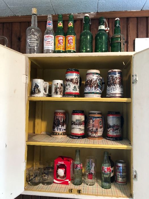 Budweiser steins, Coca-Cola bottles, Jack Daniel's glasses, beer bottles, Norman Rockwell mugs