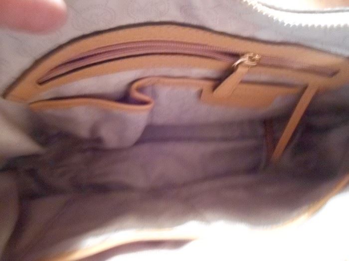 Many pockets inside both Michael Kors purses