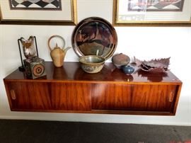 Gorgeous Mid Century Rosewood Floating Credenza with sliding doors and pullout drawer.