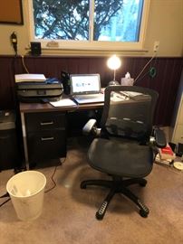 Desk and chair as well as a shredder, printer and filing cabinet.
