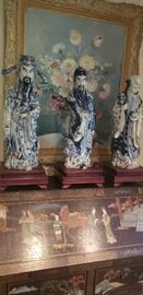 Three Moon Gods blue/white porcelain figurines - large, on mahogany stands. 