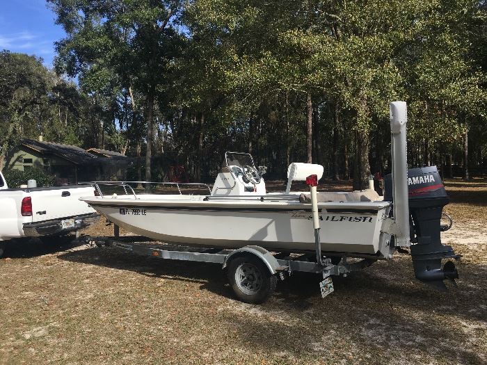 Saillfish 18'Fishing Boat  with 90 HP motor, spacious deck, hydraulic anchorstick, retractible swim steps, and trailer.