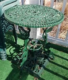 Vintage wrought iron patio table with umbrella stand