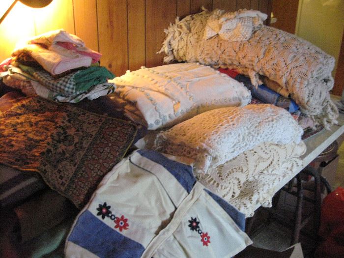 Handmade crocheted tablecloths and bedspread.  Old aprons and a vintage clothespin dress.