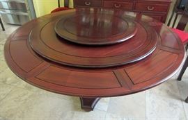Very unique ROSEWOOD table purchased in England with Lazy -Susan accessory on top.  The outer sections fold and slide under the top for the smallest size, and when expanded the center piece rotates down to make the large diameter table. 