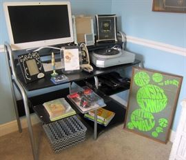 Some electronics, stand, one of several Rock posters