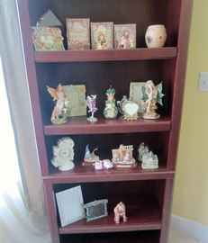 Book shelf full of ceramic accessories including Boyds