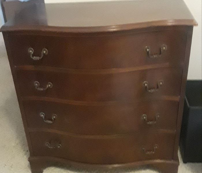 This is a serpentine style small dresser or night stand. It is newer.  