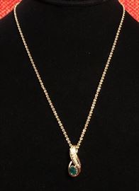 Emerald and diamond pendant set in 14 KT yellow gold on 14 KT yellow rope chain.