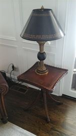 Theodore Alexander table lamp. Antique leather top piecrust table.
