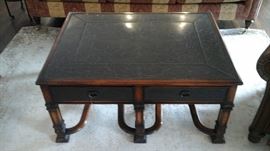 Theodore Alexander cocktail table. With leather top pull outs on both sides and etched brass panels on top and on front of drawers.