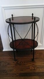 Theodore Alexander lamp table oval laurel veneer and verdigris brass on castors.