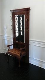 Pulaski hall tree with leather tufted seat.