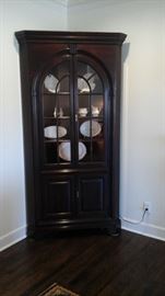 Beautiful lighted corner cabinet.