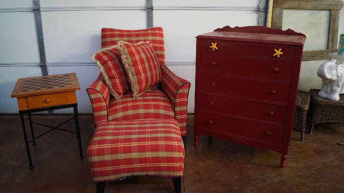 game table, chair with ottoman, red chest of drawers