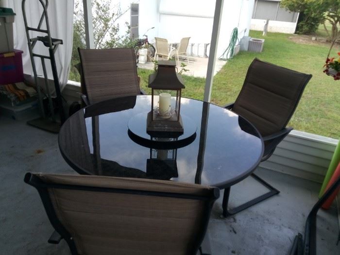Glass top patio table, 3 chairs and glass lazy-susan
