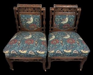 Early 20th Century Vintage Hand Carved Wooden Upholstered Side Chairs Hand carved wooden upholstered side chairs with flowers & birds. Casters on front 2 legs of both chairs. Very well made & loved