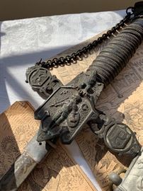 Top of sword  K.P and leather bound